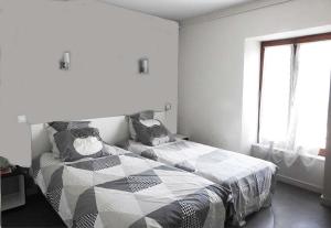 a bedroom with a bed and a window at auberge de louroux in Louroux-de-Bouble