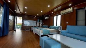 a room with two beds and a couch and a tv at Chunlii Homestay in Ke Ga