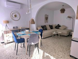 a living room with a table and a couch at La brise marine - proche de la mer in Valras-Plage