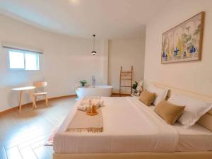 a large white bed in a room with a bathroom at Rabbit Villa Bangsaray in Bang Sare +46 photos