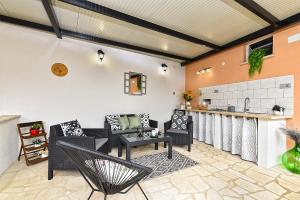 a patio with black furniture and a kitchen at House Kanižela 2418 in Nova Vas