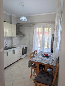 a kitchen with a table with a bowl of fruit on it at Lichnides Maisonette in Mola Kalyva