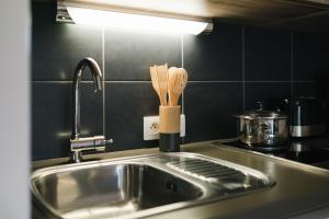 a kitchen sink with a knife block next to it at Quality Aparthotel Dinan in Dinan +12 photos