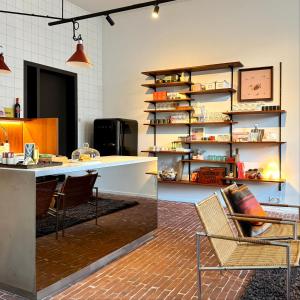 a kitchen with a counter and a table and chairs at Great to stay Gent I rooms & apartments in Ghent