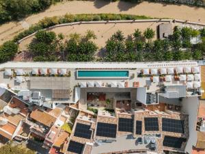 an aerial view of a building with solar panels at Elisabeth by the Sea Hotel in Tossa de Mar