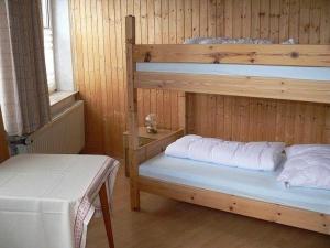 a room with two bunk beds and a table at Suederhof-Diemelsee in Diemelsee +10 photos