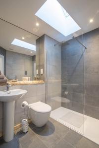 a bathroom with a shower and a toilet and a sink at The Steading InThePark in Stirling +26 photos