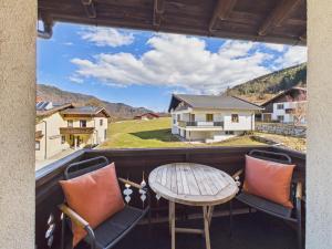 a view from the balcony of a house with a table and chairs at Boutique73 Sunrise in Ossiach