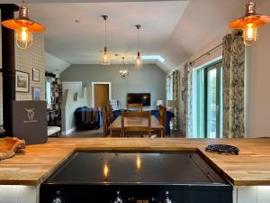 a kitchen with a counter top and a living room at The Steading InThePark in Stirling