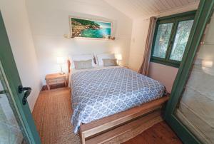 a bedroom with a bed and two lamps and a window at Mas Des Fleurs - Olive House in Perpignan +25 photos