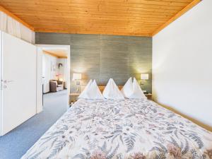 a bedroom with a large bed with white pillows at Boutique73 Sunrise in Ossiach