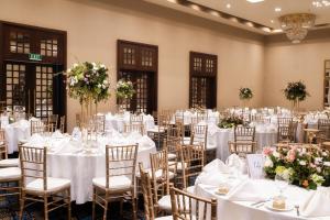a room filled with tables and chairs with white linens at The Blue Water - Geoffrey Bawa Heritage Resort Hotel in Wadduwa +70 photos