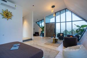 a living room with a bed and a large window at SaffronStays Luna Celeste in Rānīkhet +107 photos