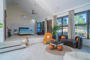 a large living room with a couch and a chair at SaffronStays Luna Celeste in Rānīkhet