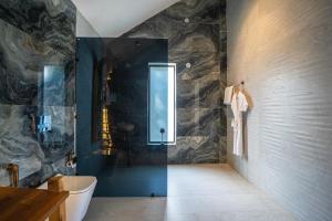 a bathroom with a shower and a toilet in it at SaffronStays Luna Celeste in Rānīkhet