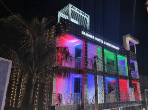 a building with colorful lights on it at night at Alishba Hotel And Restaurant in Lālbāgh