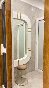 a dressing room with a stool and a mirror at Alishba Hotel And Restaurant in Lālbāgh