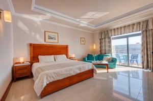 a bedroom with a bed and a living room at Paradise Bay Resort in Mellieħa