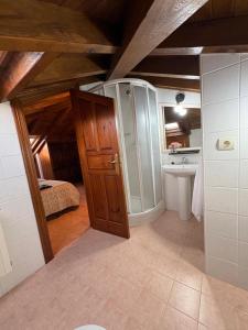 a bathroom with a shower and a sink at Eco de las Cuevas in Santillana del Mar +59 photos