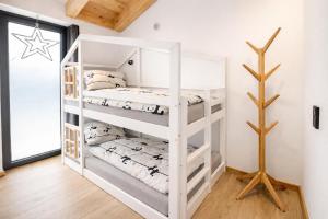 a white bunk bed in a room with a window at Mountain Residence in Going am Wilden Kaiser