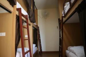 a room with four bunk beds in a dorm at HOM's HOSTEL in Phuket +66 photos