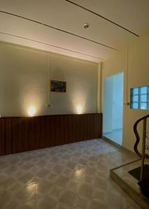 an empty room with a large room with a glass door at HOM's HOSTEL in Phuket