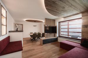 a living room with a couch and a table at Deluxe Apartments Lantl in Falzes