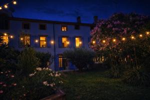 a lit up house at night with lights at Le RELAIS in Lézat-sur-Lèze +4 photos