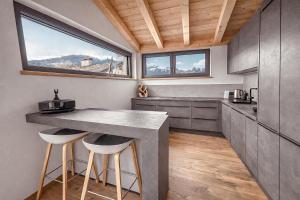 a kitchen with a counter and a large window at Mountain Residence in Going am Wilden Kaiser