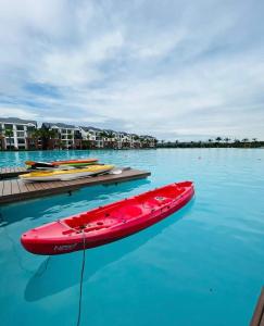 a red boat sitting on top of a body of water at The lagoon retreat in Avondzon