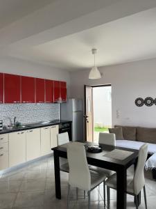 a kitchen and dining room with a table and chairs at Sun Gazing Villas in Drymon +29 photos
