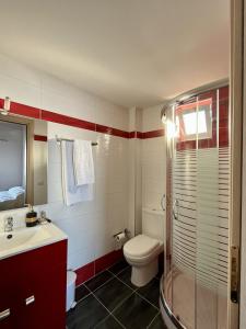 a bathroom with a toilet and a sink and a shower at Sun Gazing Villas in Drymon