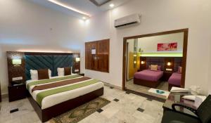 a hotel room with a bed and a mirror at Solitude, The Boutique Hotel- Ultra Luxurious in Haldwāni