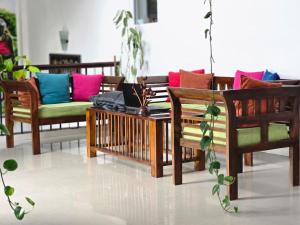 a living room with several chairs and a table at Hotel Blue Mount View Kandy in Kandy
