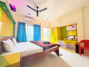a bedroom with a bed and a window and a mirror at Manas Kanya Mandarmani Hotel & Restaurant - Swimming Pool - Banquet - Parking Facility Full AC Room in Mandarmoni