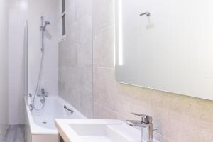 a bathroom with a sink and a tub and a mirror at La Confiance in Le Mont Saint Michel +19 photos