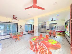 a dining room with a table and chairs at Manas Kanya Mandarmani Hotel & Restaurant - Swimming Pool - Banquet - Parking Facility Full AC Room in Mandarmoni