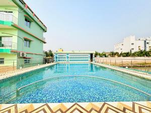 a large swimming pool in front of a building at Manas Kanya Mandarmani Hotel & Restaurant - Swimming Pool - Banquet - Parking Facility Full AC Room in Mandarmoni