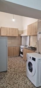 a kitchen with a washing machine in a kitchen at Niki's Cozy Home in Kalymnos