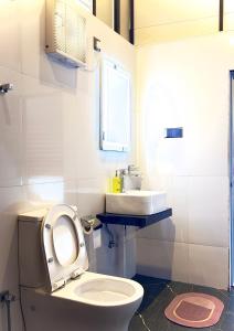 a bathroom with a toilet and a sink at Cloudy Hill Cottage in Ella +40 photos