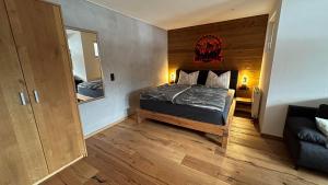a small bedroom with a bed and a mirror at Tauernchalet-S'Hoamatl in Hollersbach im Pinzgau