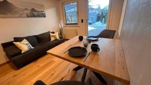 a living room with a wooden table and a couch at Tauernchalet-S'Hoamatl in Hollersbach im Pinzgau