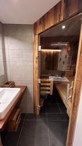 a bathroom with a sink and a bath tub at Tauernchalet-S'Hoamatl in Hollersbach im Pinzgau +34 photos