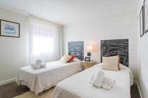 a bedroom with two beds and a window at Villa Santamaria in Colares +35 photos