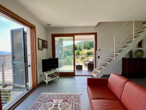 a living room with a couch and a staircase at Refugio Azul Baveno, pool and private parking in Baveno