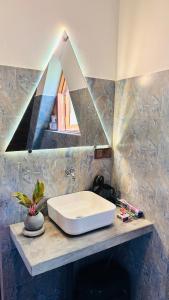 a bathroom with a white sink on a counter at Thesrilankaman village in Unawatuna