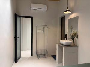 a bathroom with a sink and a glass shower at Êm Êm Homestay Đảo Lý Sơn in Ly Son