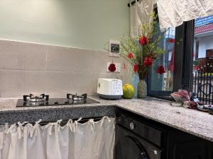 a kitchen counter with a stove and a sink at Êm Êm Homestay Đảo Lý Sơn in Ly Son +20 photos