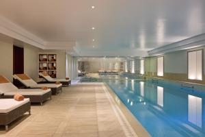 a large swimming pool in a hotel room at Majestic Hotel Spa - Champs Elysées in Paris