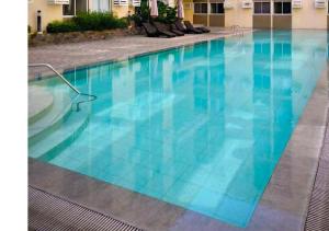 a large swimming pool with blue water in a hotel at Prime Zen in Silang